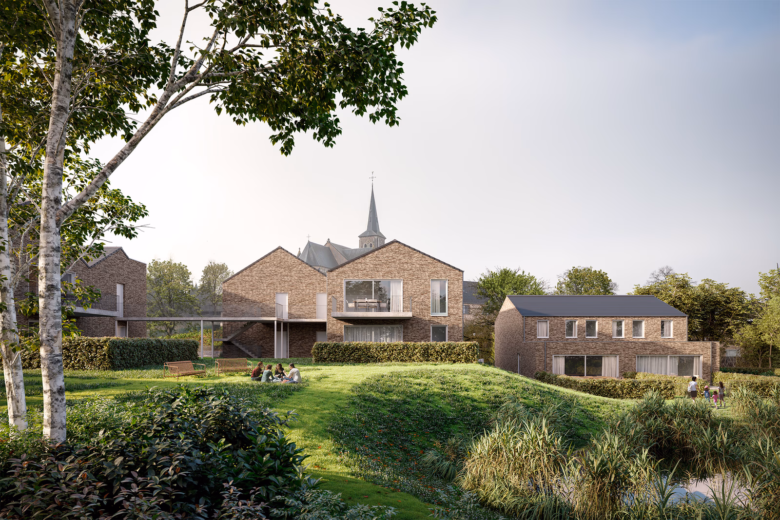 Residentie Theofiel in Tielt-Winge: bakstenen nieuwbouw aan een groene parktuin, met de kerktoren op de achtergrond